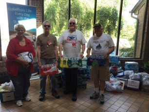 Mel Kaufhold, Dcn. Ray, John Hennessey, Maj. Tony DeStefano receives very generous collection of cases of water, summer clothing and donations from long time faithful partners from St Jude Church, Budd Lake.