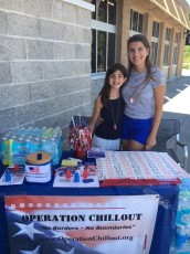 Young OPERATION CHILLOUT volunteers Leah and Lauren receive generous responses to their request for cases of water outside local supermarkets for the annual summer homeless outreach campaign.