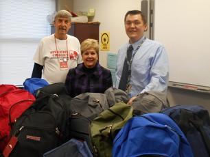 Many thanks to the students, families and staff at PORT COLDEN SCHOOL, Washington, for preparing backpacks for the annual winter outreach drive.  PICTURED from L to R: Ken Steffan, OCO Logistics Coordinator; Reading Teacher, Michelle Cooper; and School Principal Michael Neu