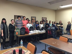 Plainfield Fanwood Rotaract members filling backpacks for annual 2015-16 winter outreach.