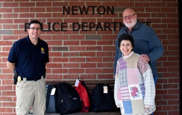 Sussex County Winter Homeless Outreach  Newton Police Chief Michael S. Richards accepts winter emergency supply backpacks from Al and Judy Gruswitz, OPERATION CHILLOUT Sussex County Location Coordinators.