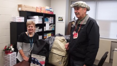Denice Jordan classroom teacher with Ken Steffan at Port Colden School with winter backpacks for deliveries.