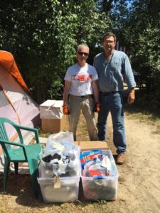  Ray and Rev. Steve with cartons of new summer clothing.