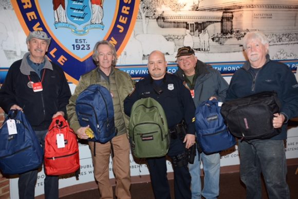Sayreville Police department launches network of support for area homeless veterans. OPERATION CHILLOUT team delivering emergency rescue backpacks to Officer Tom Calise for their outreach initiative. L to R Ken Steffan, Deacon Ray Chimileski, Tom Calise, Maj. Tony De Stefano and Kevin Ruane. Not pictured Detective Chris Engelbrot and Det. Jeremy Berry.